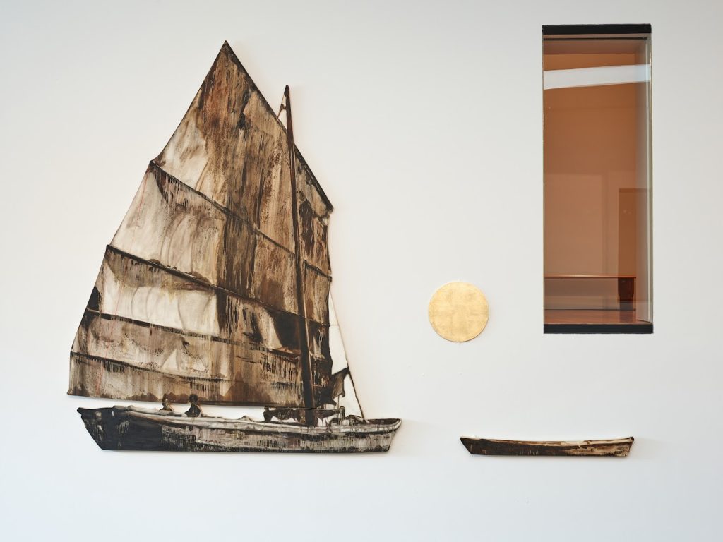 The sepia-toned “Shrimp Junk II, 1994,” painted by the artist Hung Liu, sails past the golden moon rising on the still expanse of white wall, punctured by a single reflective window.